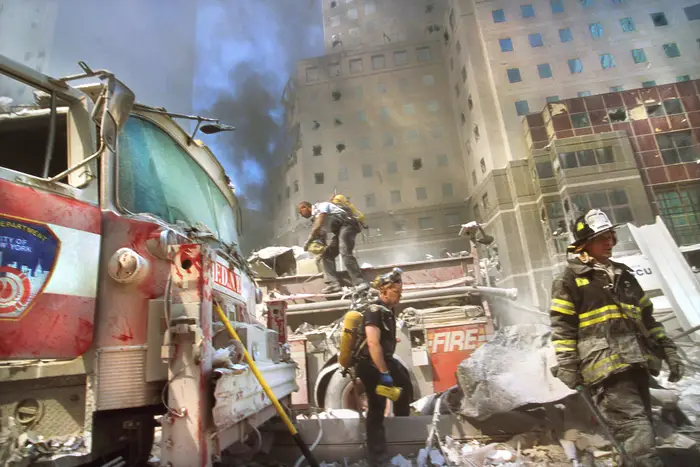 New York City fire fighters amid debris following September 11th terrorist attack on World Trade Center